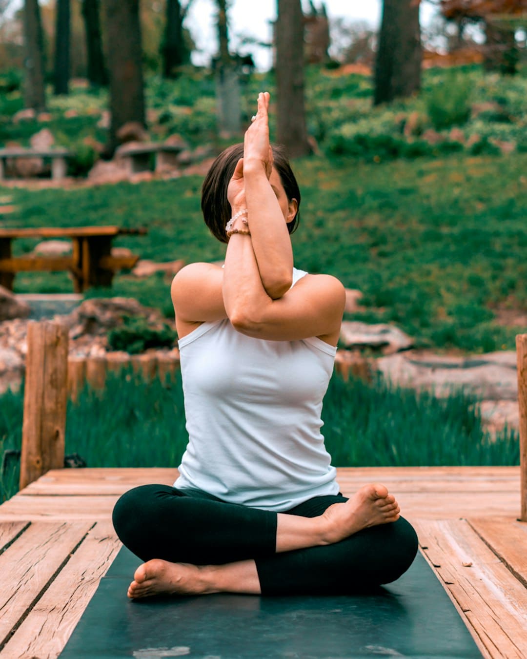 a lady doing yoga pose in open air