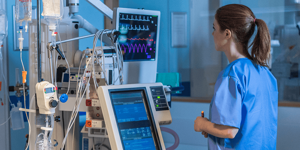 a nurse looking at a heart monitor